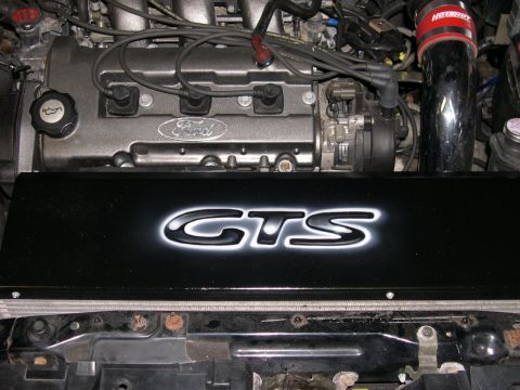 1997 Ford Probe - The engine bay features a Ford engine with a custom GTS cover and a red air intake.
