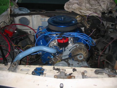 1985 Ford LTD Crown Victoria - The engine bay of a vehicle is shown with various components and wiring.