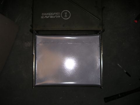 1996 Ford Bronco - An ammo can is shown open, revealing a reflective silver liner within its metal frame.
