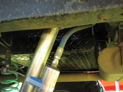 1979 Ford Bronco - Undercarriage view shows a shock absorber and a diamond plate skid plate with visible part numbers.