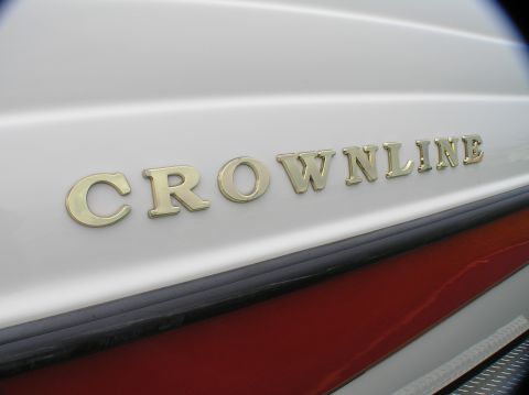 1997 Crownline 266 CCR - Close-up of the 'CROWNLINE' nameplate on a boat's hull.