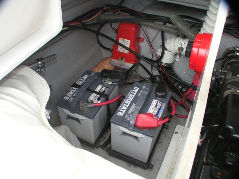 1997 Crownline 266 CCR - View of the engine compartment of a boat, showing batteries and various components.