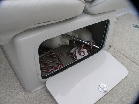 1997 Crownline 266 CCR - Interior storage compartment of a boat, containing fenders and rope.