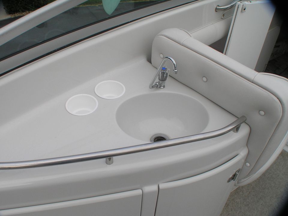 Boat wet bar with sink, chrome faucet, cup holders and grab rail
