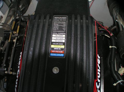 1997 Crownline 266 CCR - The engine compartment of a boat, showing the Mercruiser engine and its identification label.