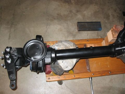 1995 Ford Bronco - Front axle assembly, likely for a 4x4 vehicle, is black and appears to be recently serviced or painted.