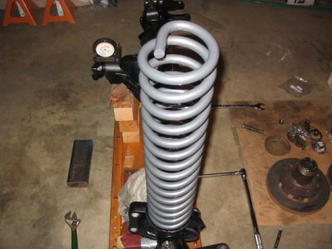 1995 Ford Bronco - A close-up view of a suspension coil and shock assembly, likely undergoing maintenance or modification.