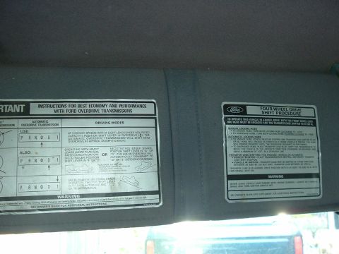 1989 Ford Bronco - Interior sun visor displays instructions for Ford overdrive transmissions and four-wheel drive operation.