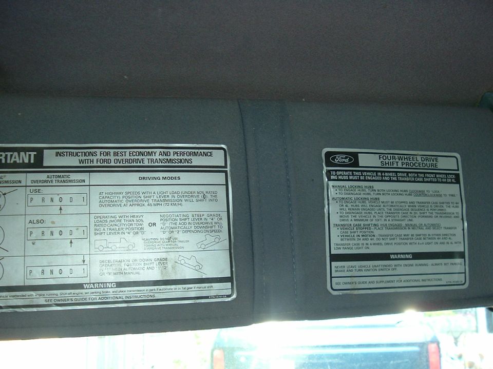 Sun visor labels for Ford overdrive transmission driving modes and four-wheel drive shift procedure