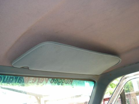1989 Ford Bronco - Interior view of a vehicle's headliner and sun visor, with text on the windshield.