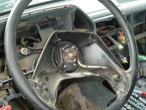 1989 Ford Bronco - The steering column is partially disassembled, revealing the internal components and wiring harness.