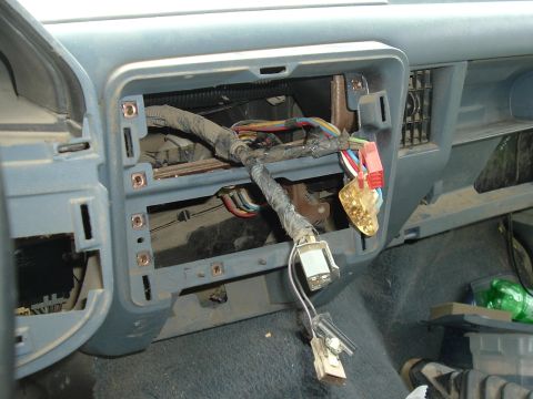 1989 Ford Bronco - Exposed wiring and connectors are visible in the dashboard of a vehicle during a tear-down.