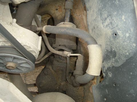 1989 Ford Bronco - Underside view of a vehicle's engine compartment, focusing on the power steering pump and associated hoses.