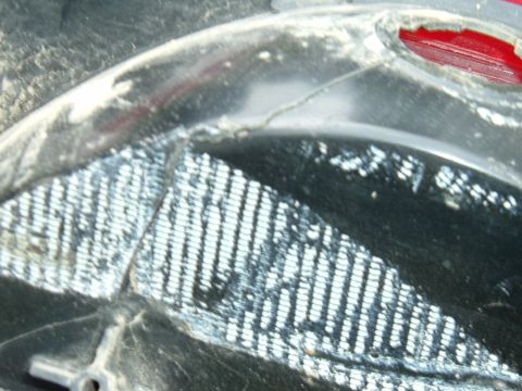 1989 Ford Bronco - Detail of a vehicle's grille section showing a mesh pattern and a red light.