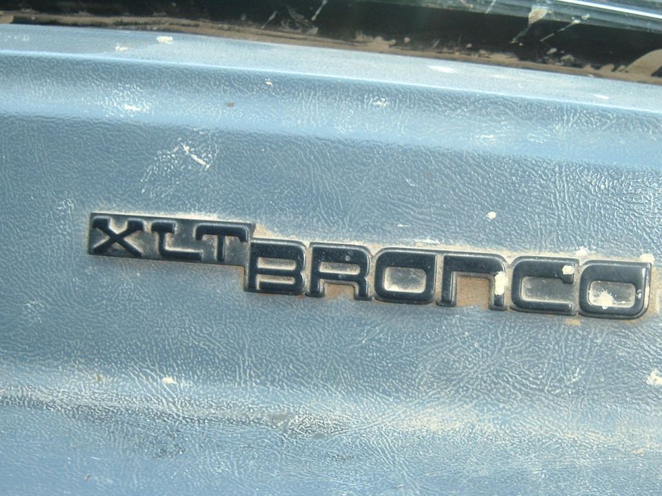 XLT Bronco emblem on blue textured surface