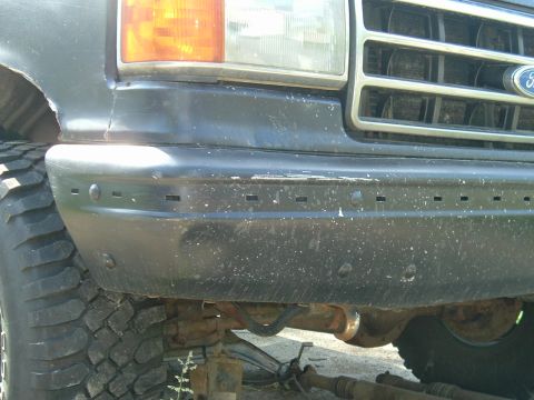 1989 Ford Bronco - Close-up of the front bumper and tire on a 1989 Ford Bronco.