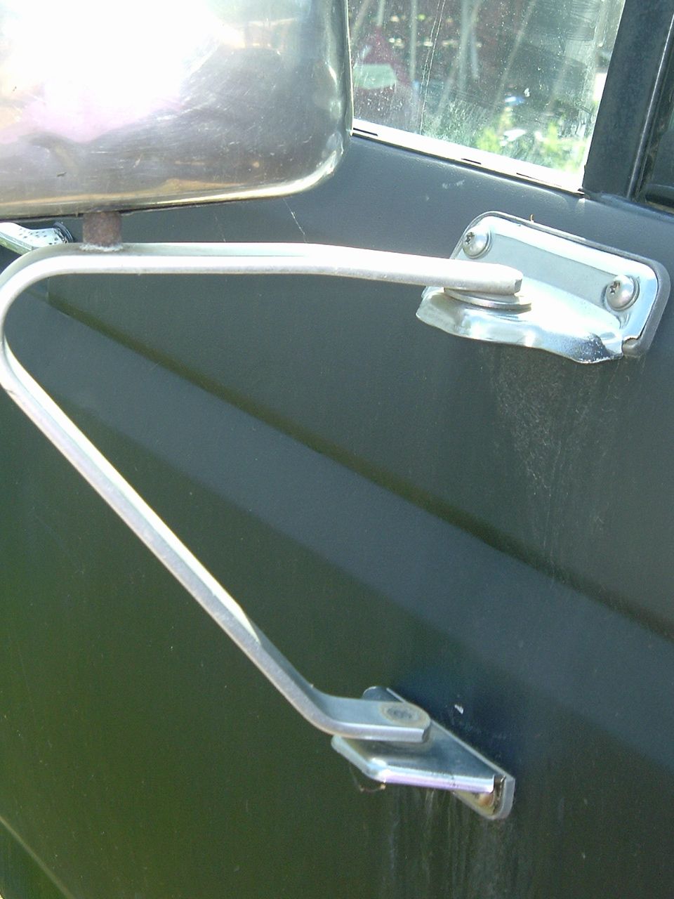 Side mirror arm and mount on a dark vehicle