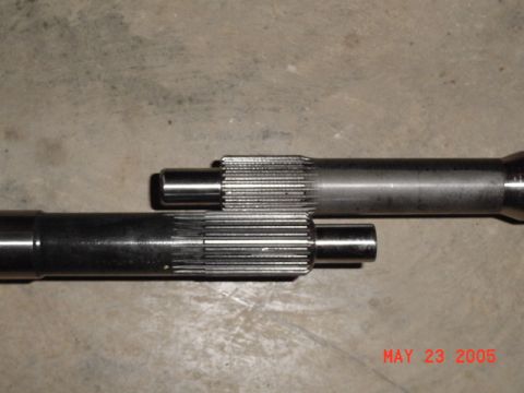 2003 Ford Mustang - Two metal shafts with splined ends are shown on a concrete surface. A date stamp indicates May 23, 2005.