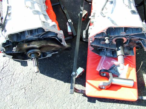 2003 Ford Mustang - Two car transmissions are shown disassembled, with visible shafts and casings.