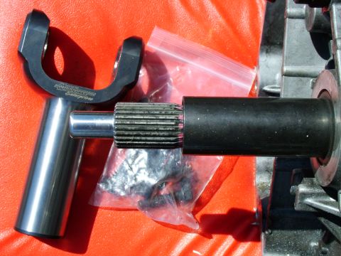 2003 Ford Mustang - A driveshaft yoke, identified with 'QA1 Williams Enterprises' text, is shown alongside a splined shaft and part of a transmission housing.