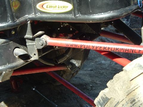 1989 Ford Bronco - Close-up of off-road suspension components, including a Detroit Locker sticker and "WWW.POLYPERFORMANCE" branding.