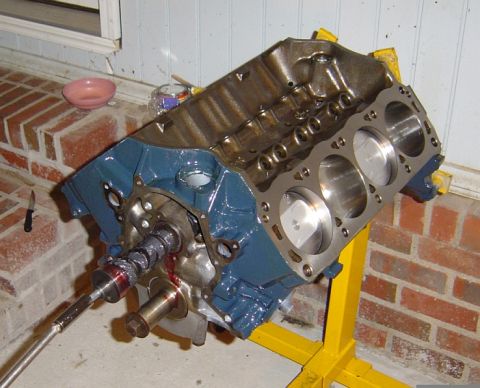 1986 Ford Bronco - Engine block with pistons and camshaft visible, mounted on a stand.