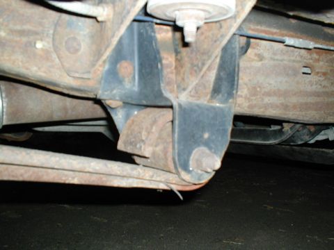 1979 Ford Bronco - This photo shows the rusty undercarriage of a vehicle, focusing on the suspension system and its components.