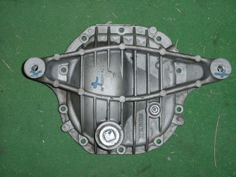 1989 Ford Bronco - A close-up view of a vehicle's differential cover, showing its ribbed design and mounting holes.