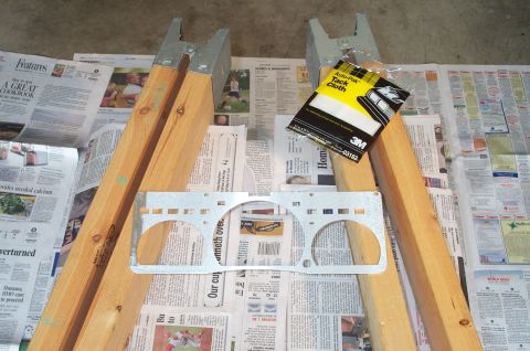 1998 Ford Crown Victoria - A custom gauge cluster trim panel is laid out on newspapers, with wooden supports and a tack cloth nearby.