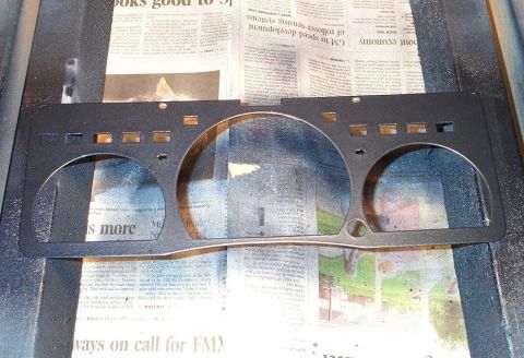 1998 Ford Crown Victoria - A custom gauge cluster trim panel is shown, resting on a surface covered with newspapers.