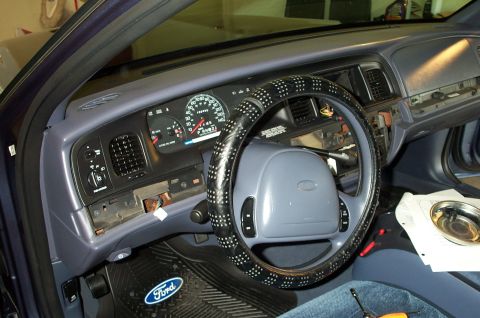 1998 Ford Crown Victoria - Interior view of a 1998 Ford Crown Victoria, showing the dashboard, steering wheel, and gauges, with some trim panels removed.
