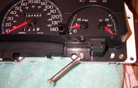 1998 Ford Crown Victoria - I used a 7/32" wrench to remove the bolts that hold the lense on the cluster and the cluster mask.