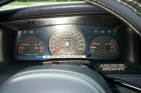 1998 Ford Crown Victoria - Interior view of a car's dashboard gauges, including speedometer and warning lights.
