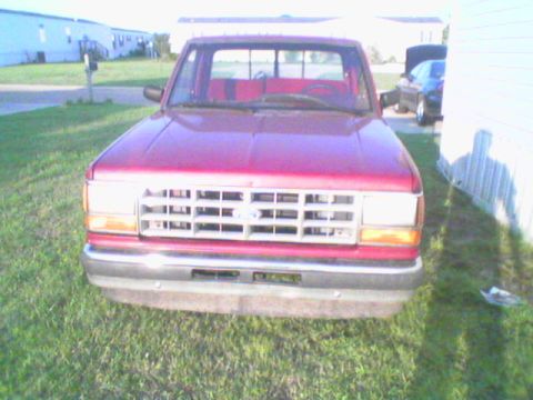 1990 Ford Ranger - Front view of a red 1990 Ford Ranger pickup truck parked on grass.