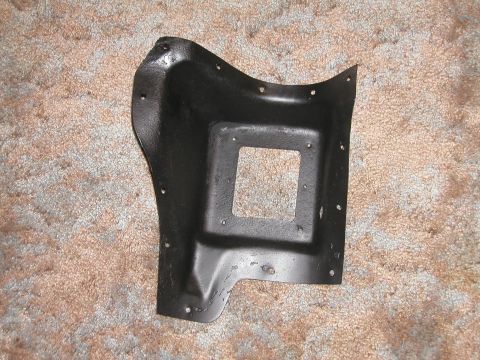 1966 Ford Fairlane - This black metal automotive part has a square cutout and numerous mounting holes.