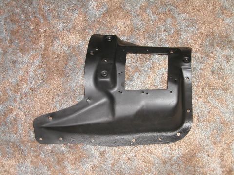 1966 Ford Fairlane - This black metal automotive part is a splash shield, likely for a fender, shown on a carpeted surface.