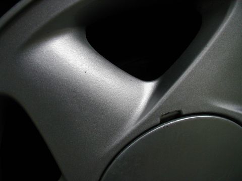 1997 Ford Taurus - Close-up view of a silver alloy wheel rim, showing its spoke design and texture.