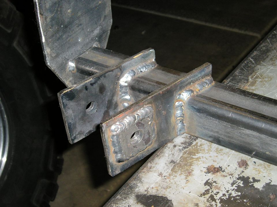 welded 3/16 plate around the bolt hole to prevent the bolt from pulling through the bracket.