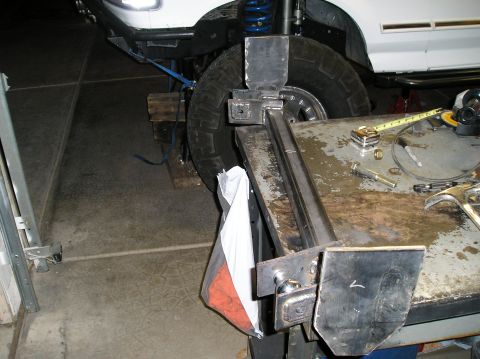 1993 Ford Bronco - Custom suspension modifications are underway on a 1993 Ford Bronco, with tools laid out on a workbench nearby.
