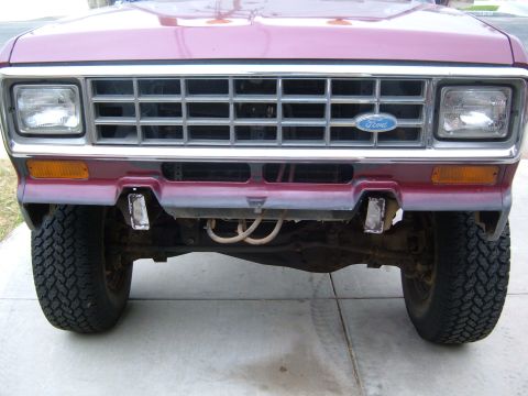 1985 Ford Bronco II - Close-up of the front grille and headlights of a maroon Ford Bronco II.