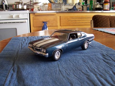 1995 Ford Bronco - Model car with racing stripes sits on a blue cloth on a table.