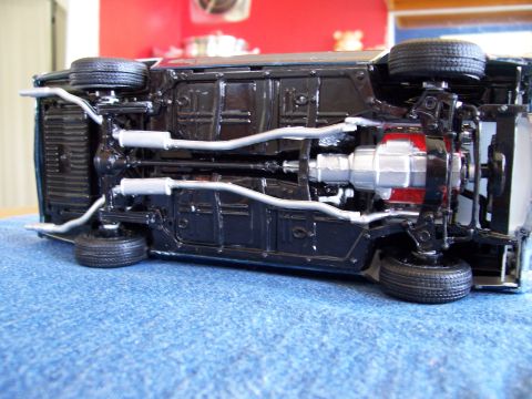 1995 Ford Bronco - A detailed view of the underside of a toy car, revealing its mechanical components.