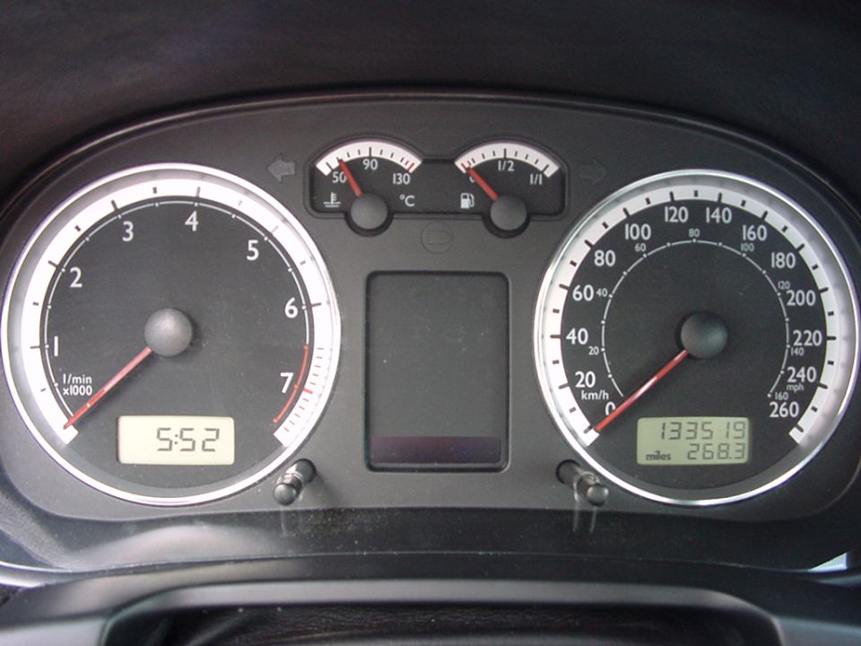 1998 Volkswagen Jetta dashboard with tachometer, speedometer, fuel gauge, temperature gauge, and digital clock