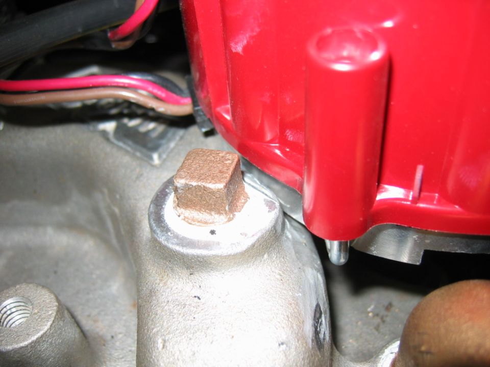 Close-up of a red engine distributor cap with wires