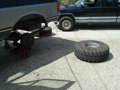 1989 Ford Bronco - Two trucks are visible, with one undergoing maintenance on its rear axle.