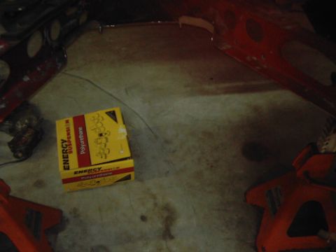 1978 Ford Bronco - A box of Energy Suspension polyurethane parts sits on a concrete floor, with parts of a vehicle frame visible.