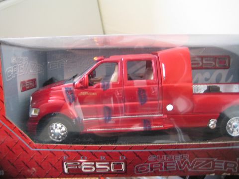 1990 Ford Bronco - red Ford F-650 Super CrewZer crew-cab die-cast model displayed inside its retail window box.