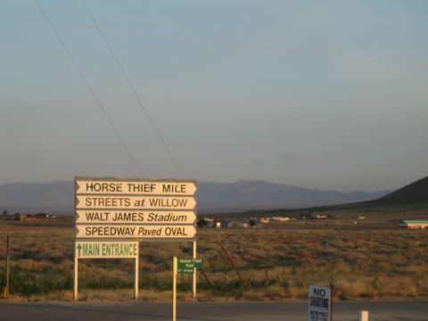 1990 Ford Bronco - roadside directional sign listing Horse Thief Mile, Streets at Willow, Walt James Stadium and Speedway paved oval.