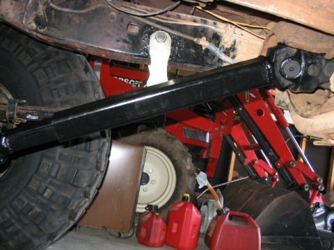 1986 Ford F-150 - Underside view shows drivetrain components, jerry cans, and a hydraulic jack.