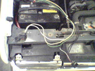 1990 Ford Bronco - Close-up view of an engine bay, showing the battery and wiring.